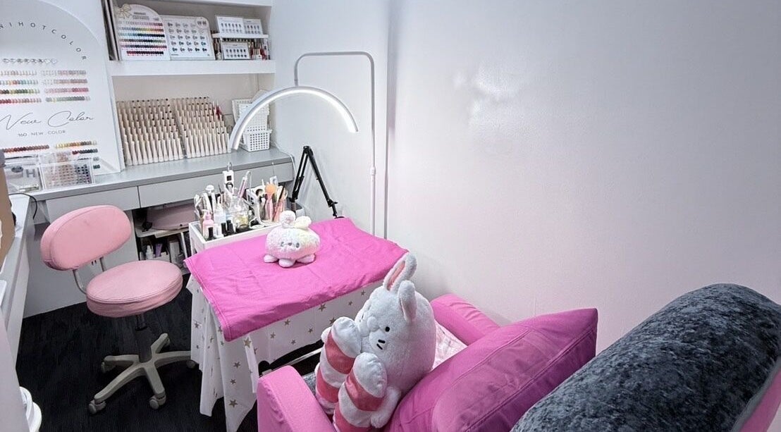 Cozy nail salon interior at Nails By Ting, Singapore, SG, featuring pink decor and beauty tools.