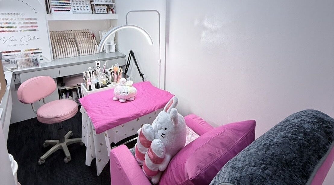 Cozy nail salon setup at Nails By Ting, Singapore, Singapore, SG featuring pink decor and plush items.