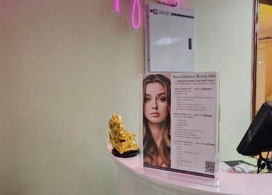 Reception area at Renu Sachdeva Beauty Saloon in Abu Dhabi with menu and decor.
