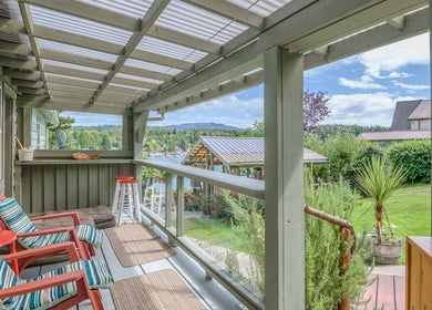 Relax on the covered terrace at Shinrin-Yoku Spa in Bamfield, British Columbia, CA, with serene garden views.