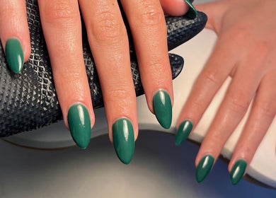 Emerald green nails at Cured. By Olivia, Cardiff, Wales, GB, showcasing elegant manicure.