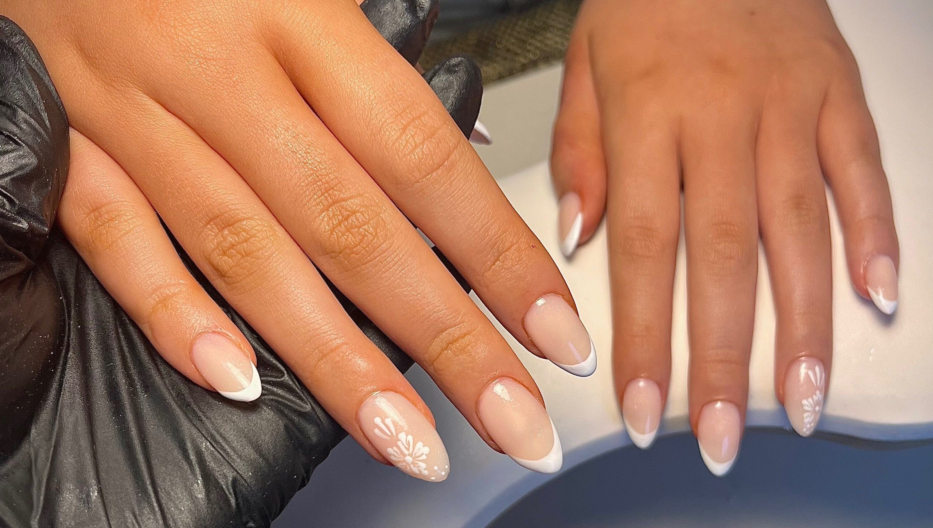 Elegant French manicured nails at Cured. By Olivia, Cardiff, Wales, GB showcasing detailed nail art.