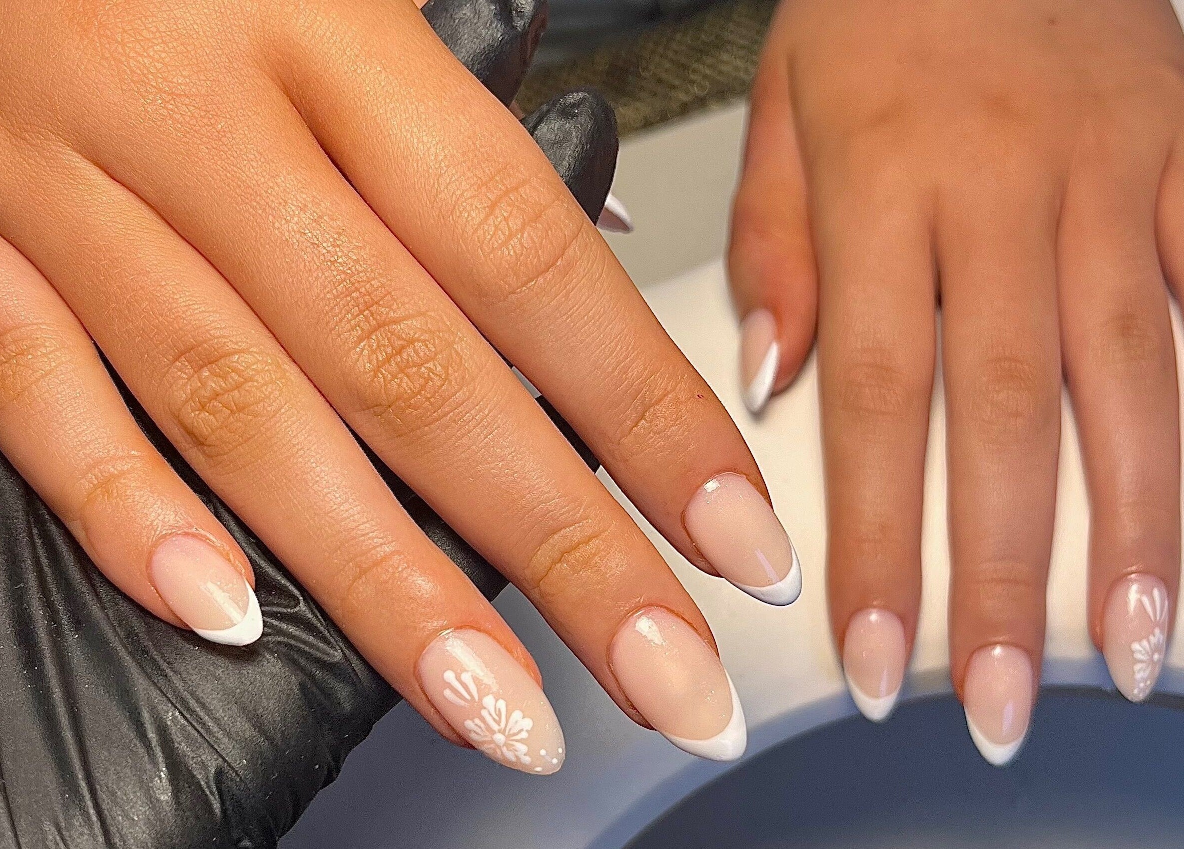 Elegant French manicured nails at Cured. By Olivia, Cardiff, Wales, GB showcasing detailed nail art.