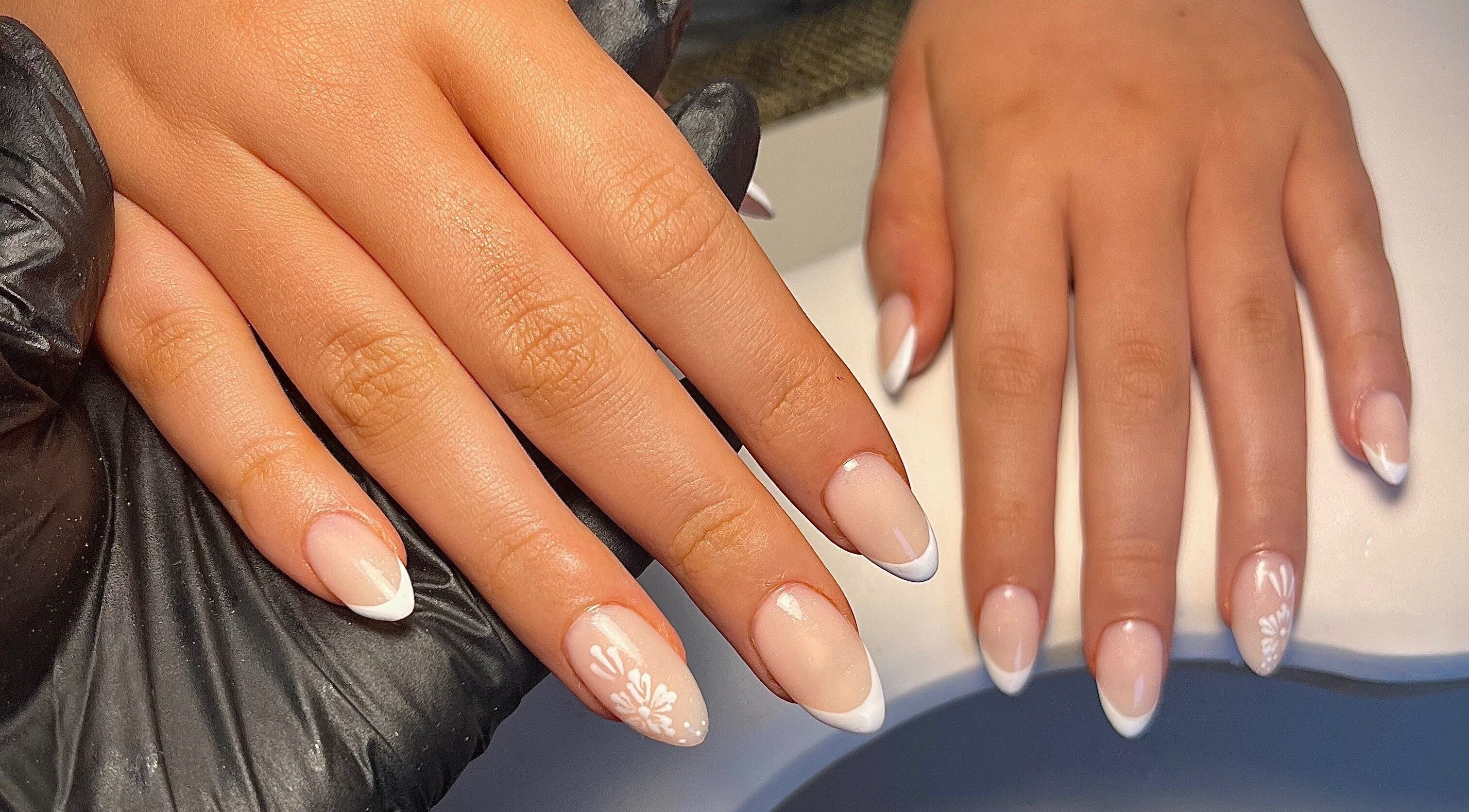 Elegant French manicured nails at Cured. By Olivia, Cardiff, Wales, GB showcasing detailed nail art.