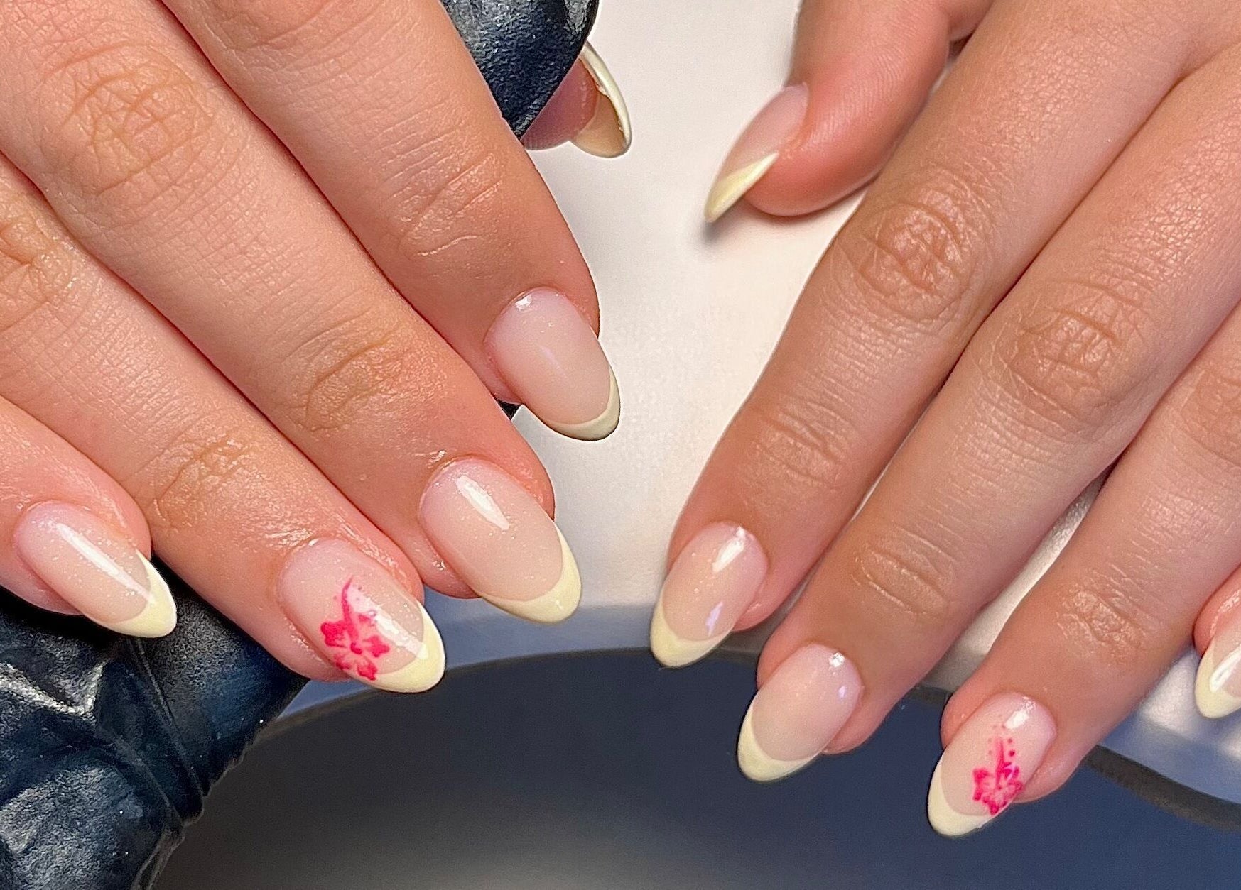 Elegant nail design with floral accents at Cured. By Olivia, Cardiff, Wales, GB.