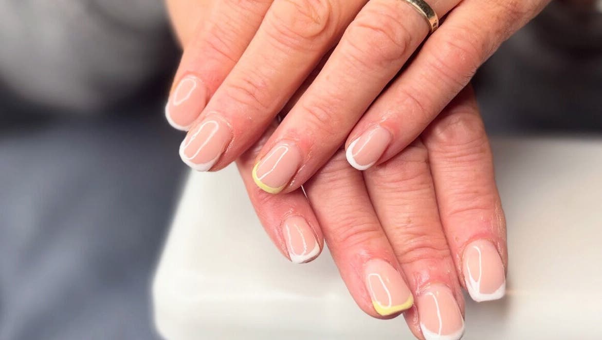Elegant French manicure with yellow accents at Just Gel Studio, Kemsing, England, GB.
