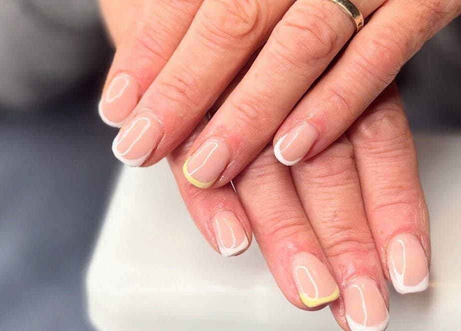 Elegant French manicure with yellow accents at Just Gel Studio, Kemsing, England, GB.