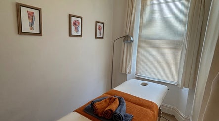 Relaxing massage room at Krida Massage Therapy, Torquay, England, GB with a massage table and calming art.
