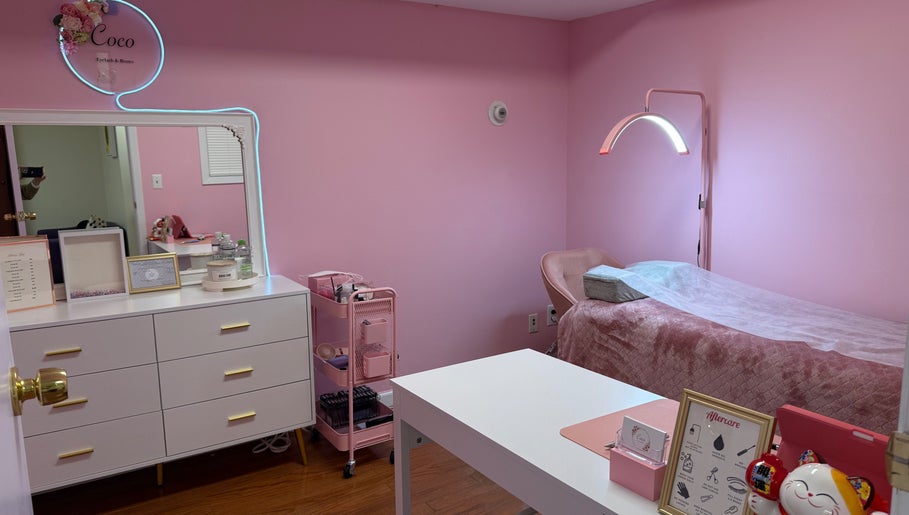 Elegant pink treatment room at COCO EYELASH & BROWS.LLC, New York, New York, US, featuring a cozy setup.