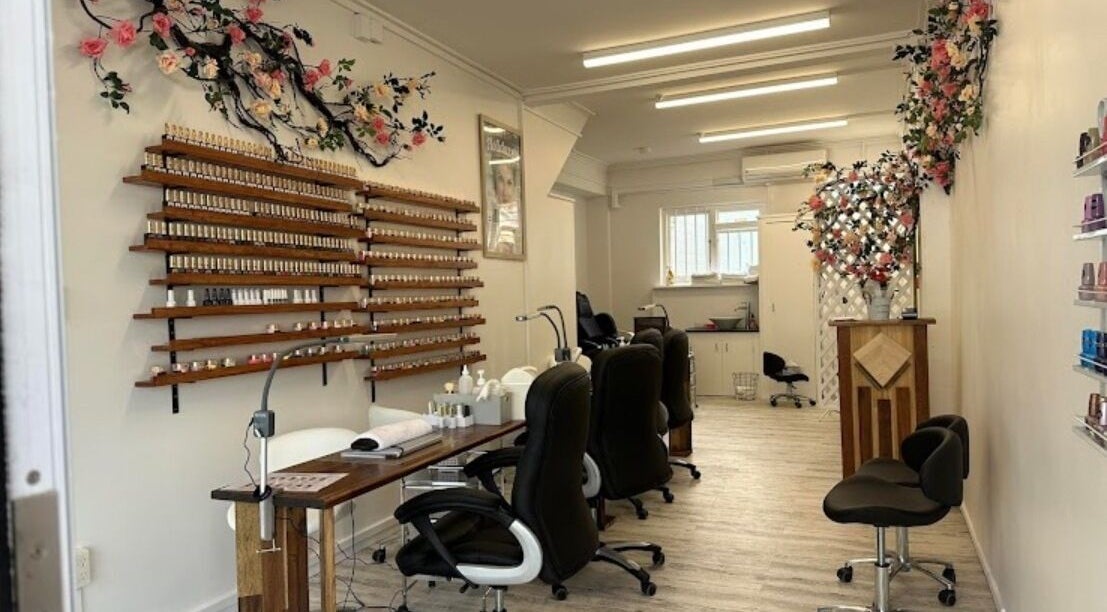 Interior of Royal Nails and Beauty in Wellington, NZ, showcasing chic nail polish display and floral decor.