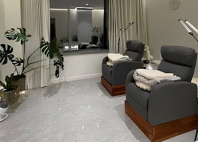 Relaxing lounge at MIU MIU EYELASHES in Sydney, New South Wales, AU with plush chairs and modern decor.