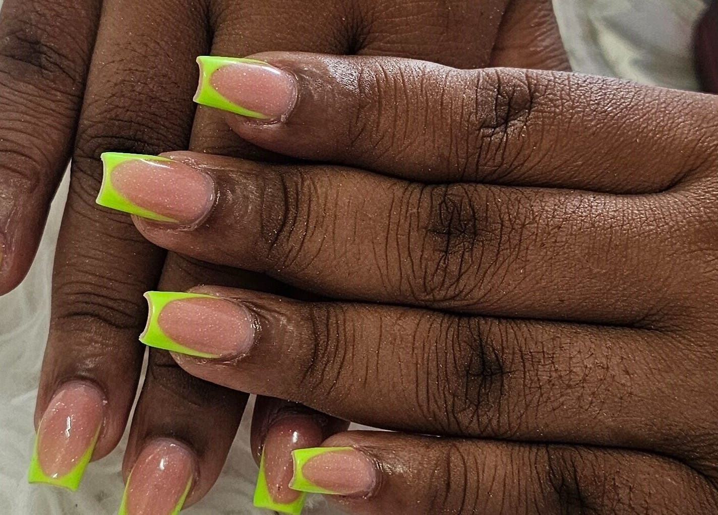 Neon-tipped nails from Get_nailed784studio, Charlotte, VC, showcasing vibrant nail art.