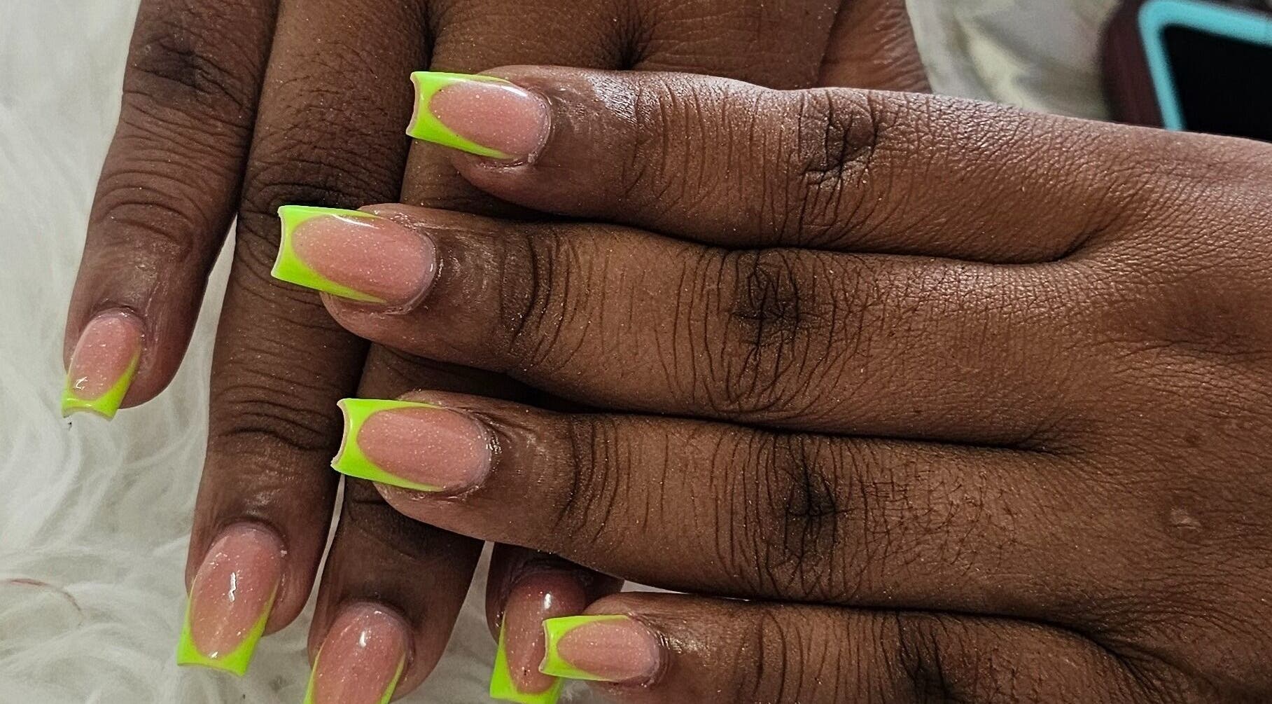 Neon-tipped nails from Get_nailed784studio, Charlotte, VC, showcasing vibrant nail art.