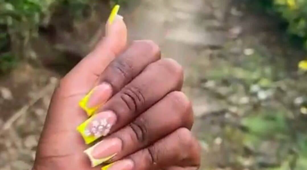 Close-up of floral nail art with yellow accents at Get_nailed784studio, Charlotte, Charlotte, VC.