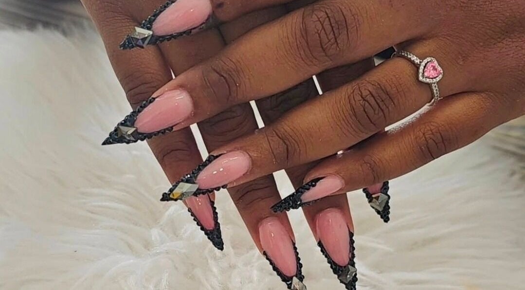 Elegant nail art at Get Nailed784studio in Charlotte, VC showcasing intricate black and pink design.