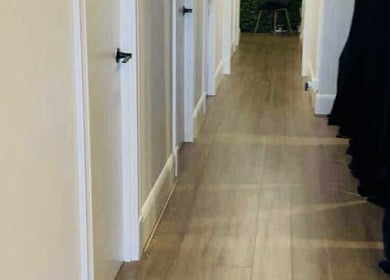 Bright hallway interior at Lavina Beauty in Hampton, Victoria, AU, showcasing elegant wooden flooring.
