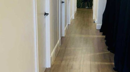 Bright hallway interior at Lavina Beauty in Hampton, Victoria, AU, showcasing elegant wooden flooring.