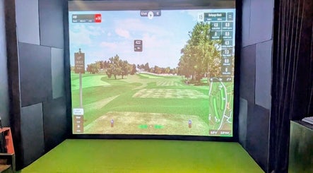 Virtual golf simulator at The 19th Hole, Bali, Bali, ID showing a serene golf course landscape.