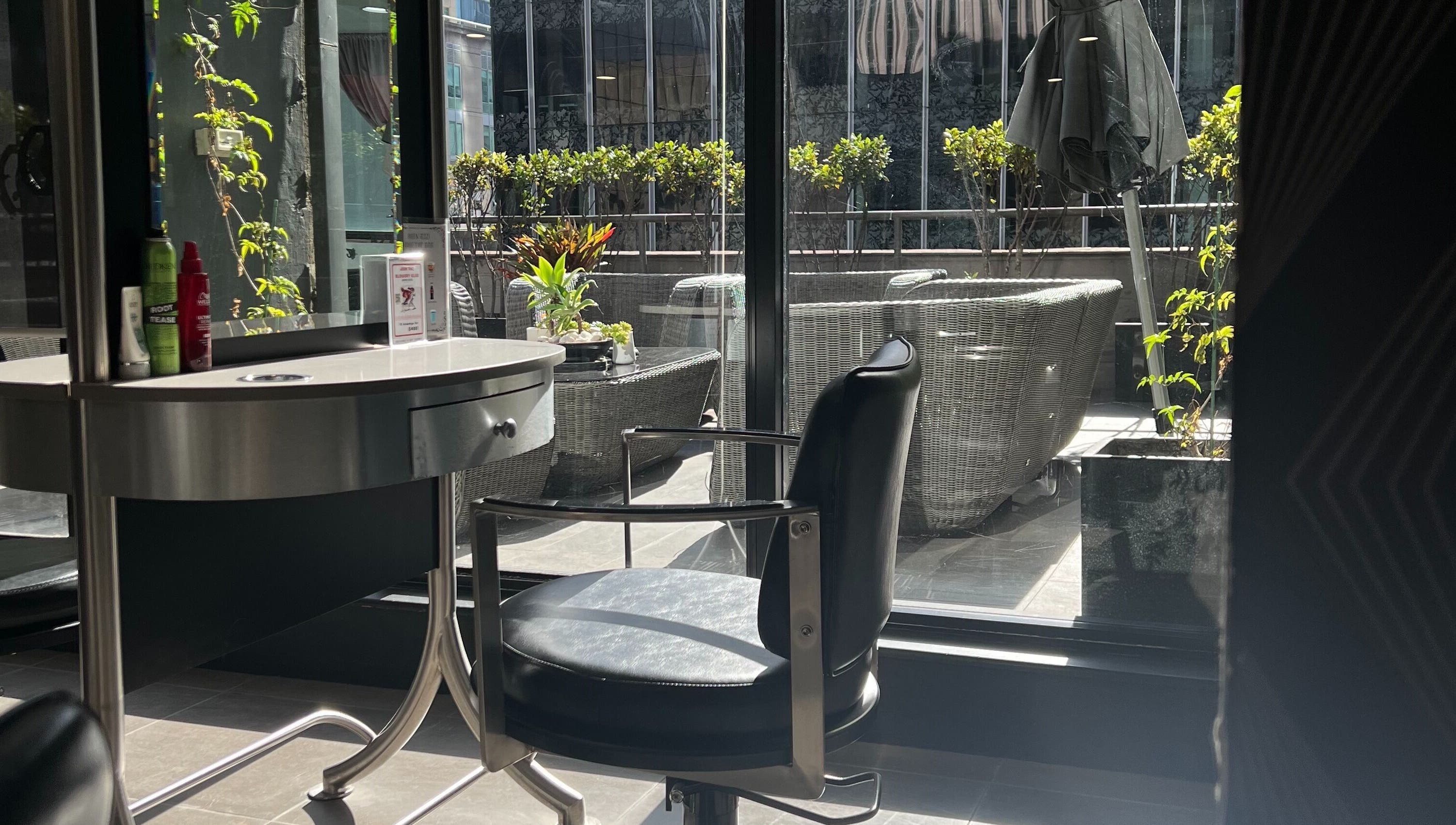 Sleek salon interior with scenic view at John Azzi Hairdressers, Sydney, New South Wales, AU.