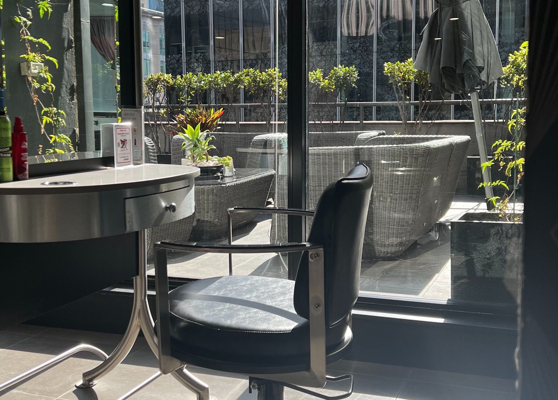 Sleek salon interior with scenic view at John Azzi Hairdressers, Sydney, New South Wales, AU.