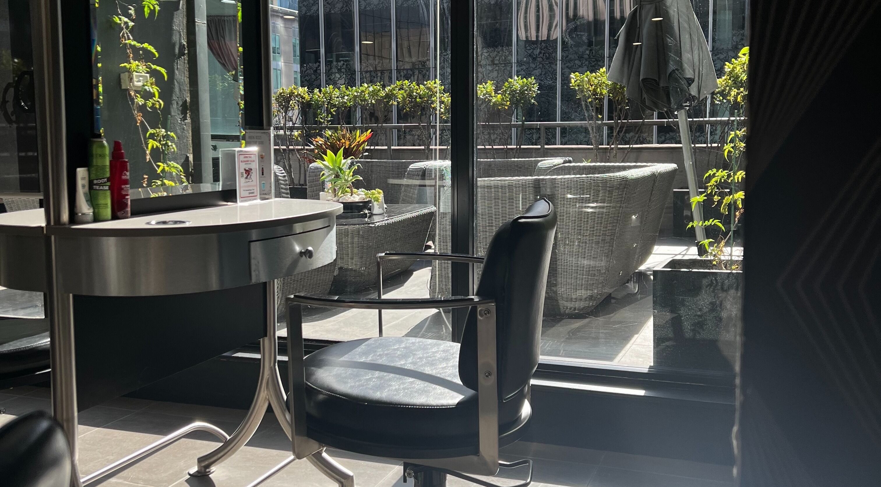 Sleek salon interior with scenic view at John Azzi Hairdressers, Sydney, New South Wales, AU.