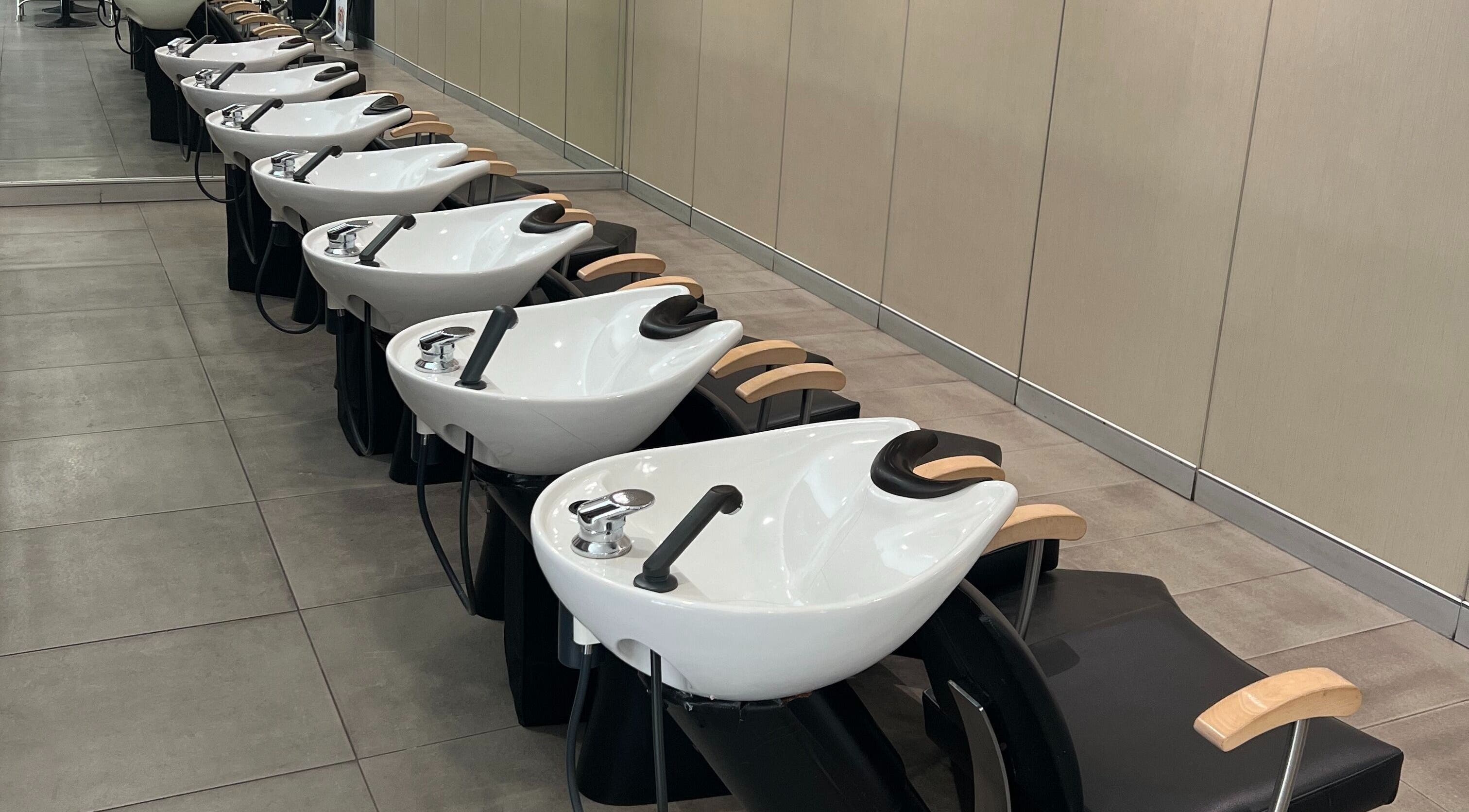Modern washstations at John Azzi Hairdressers, Sydney, New South Wales, AU, showcasing sleek salon interior.