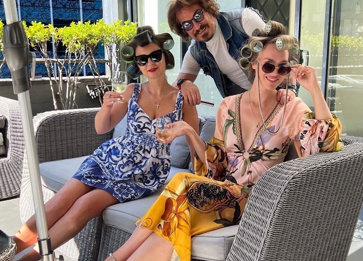 Guests enjoy a relaxing day with drinks and hair rollers at John Azzi Hairdressers, Sydney, New South Wales, AU.