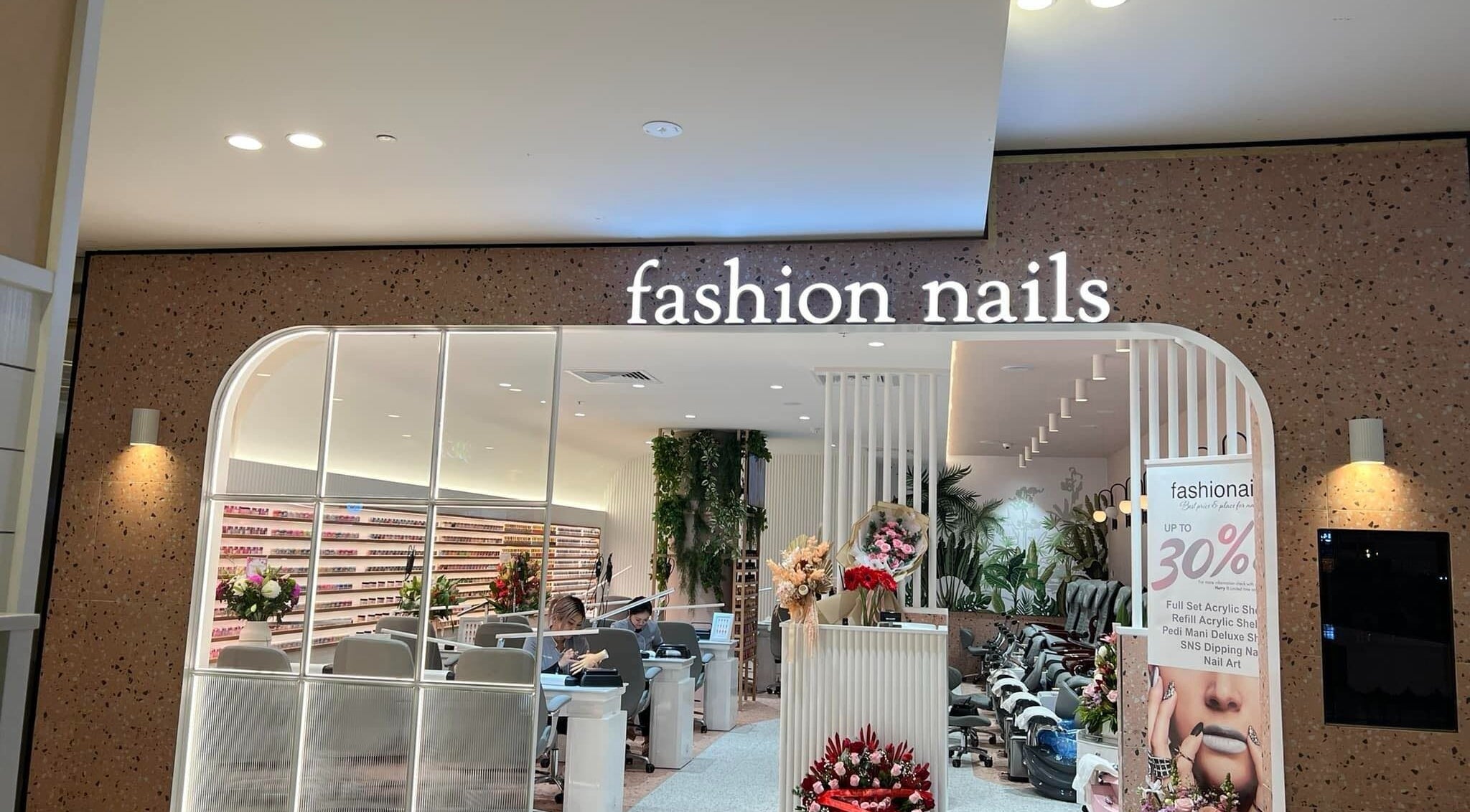 Entrance of Fashion Nails & Beauty in Oaklands Park, South Australia, showcasing modern interior and nail service stations.