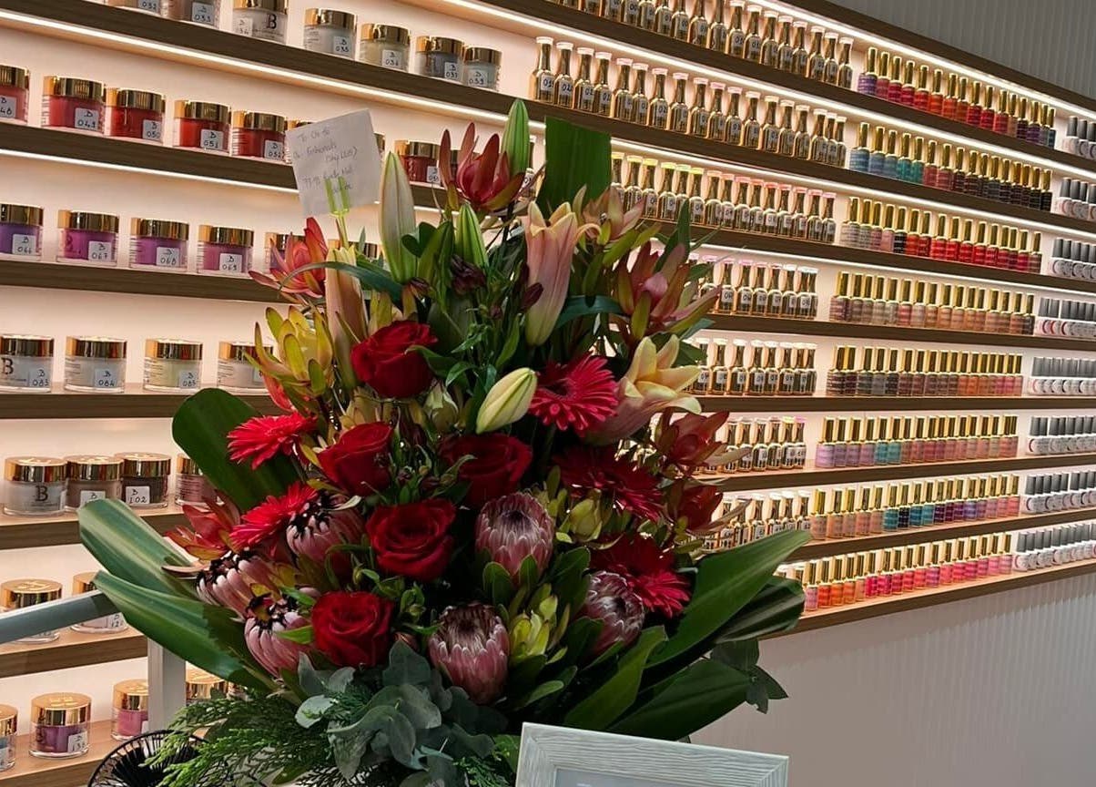Nail polish display and floral arrangement at Fashion Nails & Beauty, Oaklands Park, South Australia, AU.