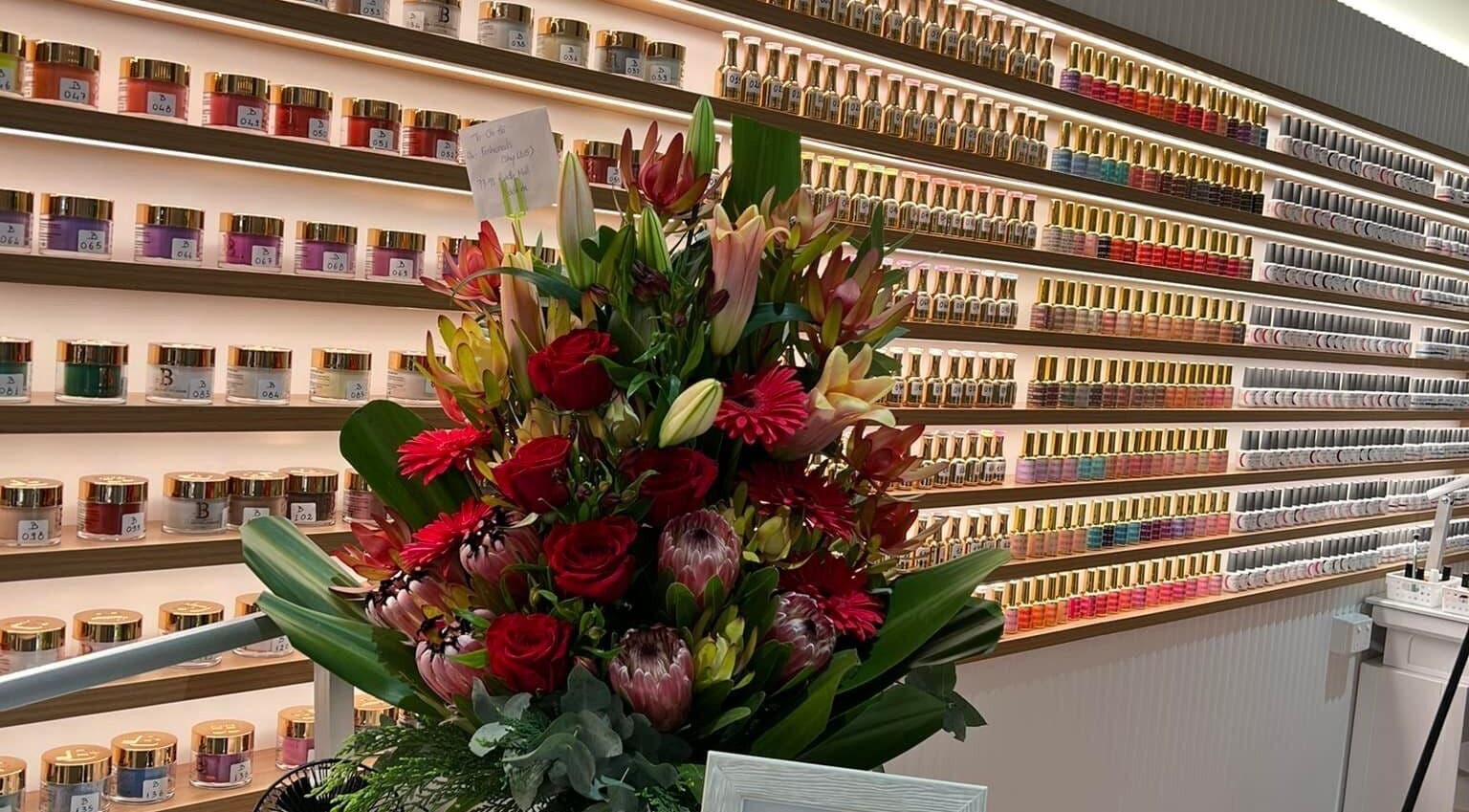 Nail polish display and floral arrangement at Fashion Nails & Beauty, Oaklands Park, South Australia, AU.