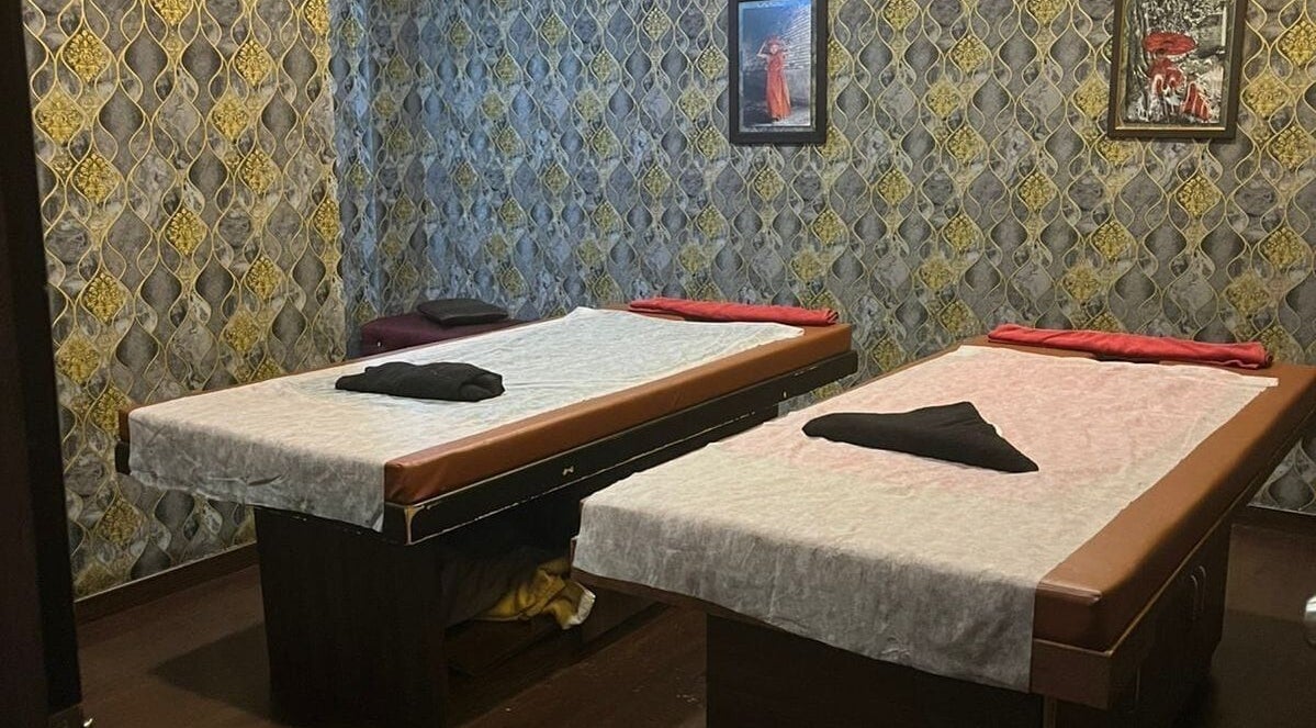 Elegant massage room at The SOFITEL wellness, Manikonda, Hyderabad, Telangana, IN with plush beds and decor.