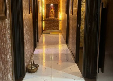 Elegant hallway at The SOFITEL wellness, Manikonda, Hyderabad with warm lighting and classic decor.
