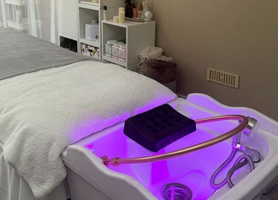 Relaxing spa treatment setup at Made Beauty in Nazeing, England, GB with calming purple lighting.