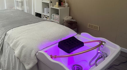 Relaxing spa treatment setup at Made Beauty in Nazeing, England, GB with calming purple lighting.