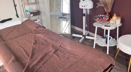 Cozy massage bed at No.6 Beauty Lounge in Winterbourne, England creates a relaxing spa atmosphere.