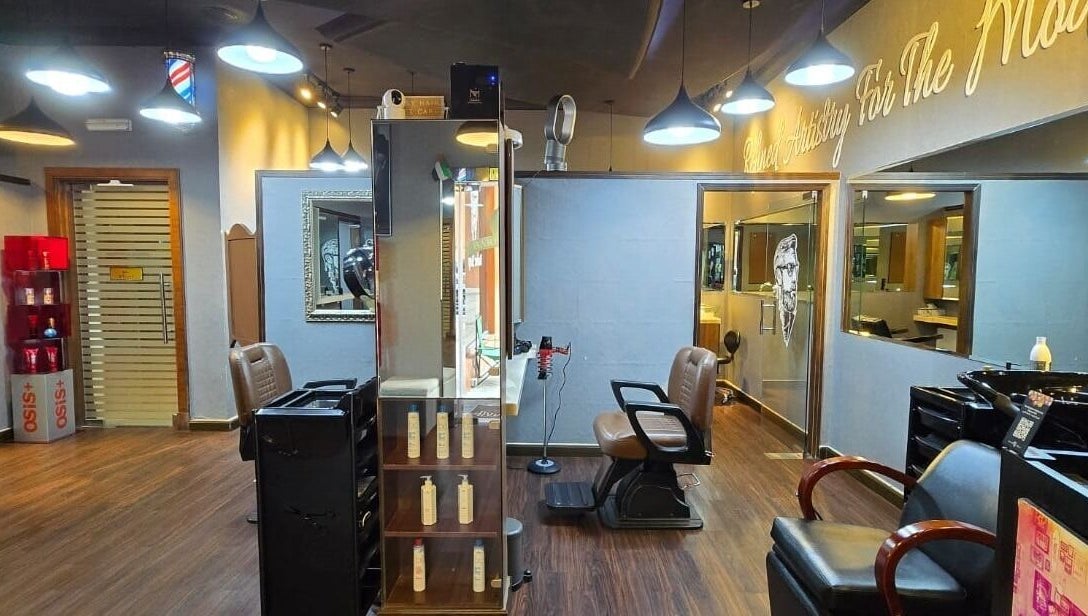 Sophisticated interior of Figaro Gentleman L.L.C, Abu Dhabi, featuring modern barber chairs and stylish decor.