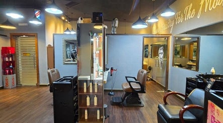 Sophisticated interior of Figaro Gentleman L.L.C, Abu Dhabi, featuring modern barber chairs and stylish decor.