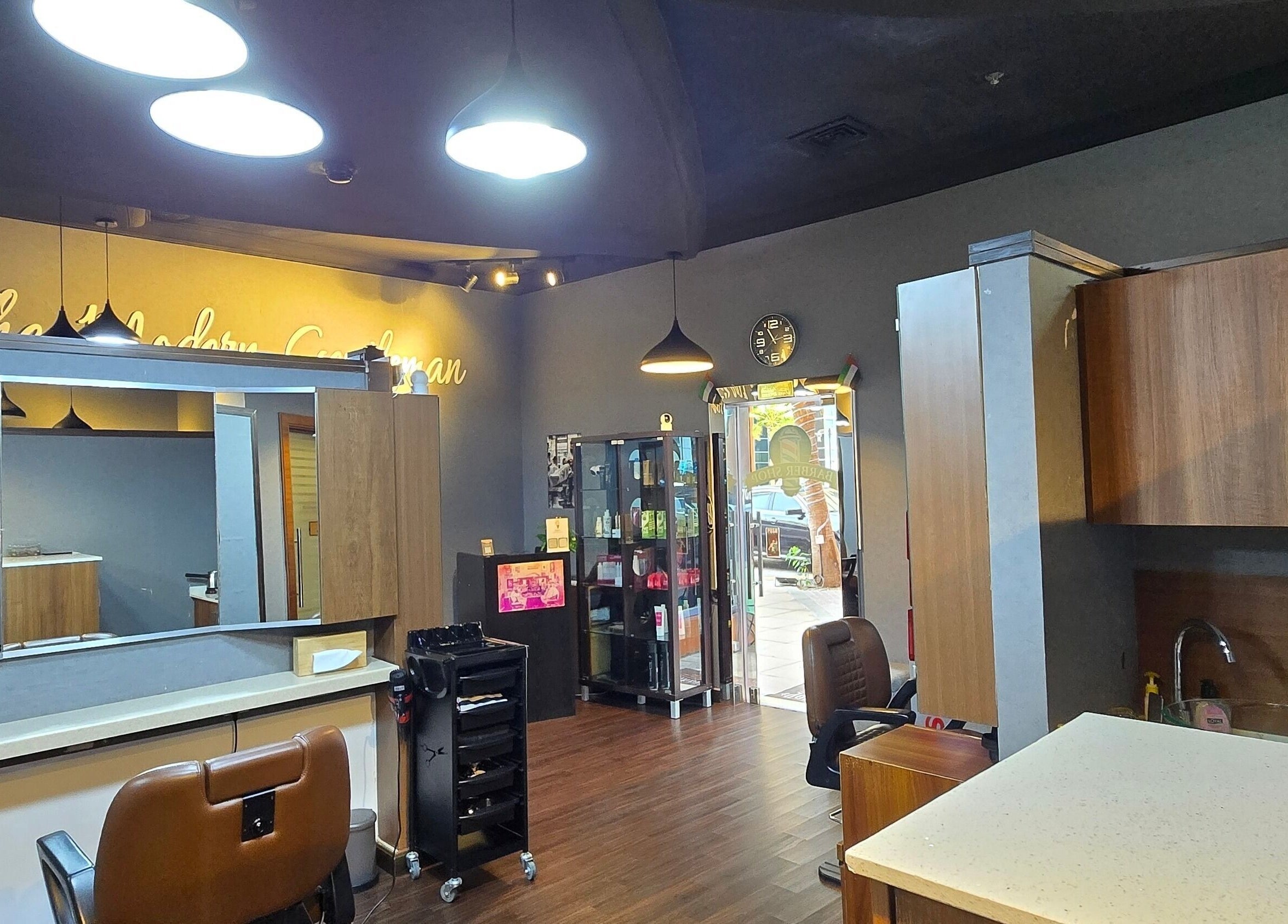 Interior of Figaro Gentleman L.L.C, barber shop in Abu Dhabi, Abu Dhabi, AE with sleek decor and styling stations.