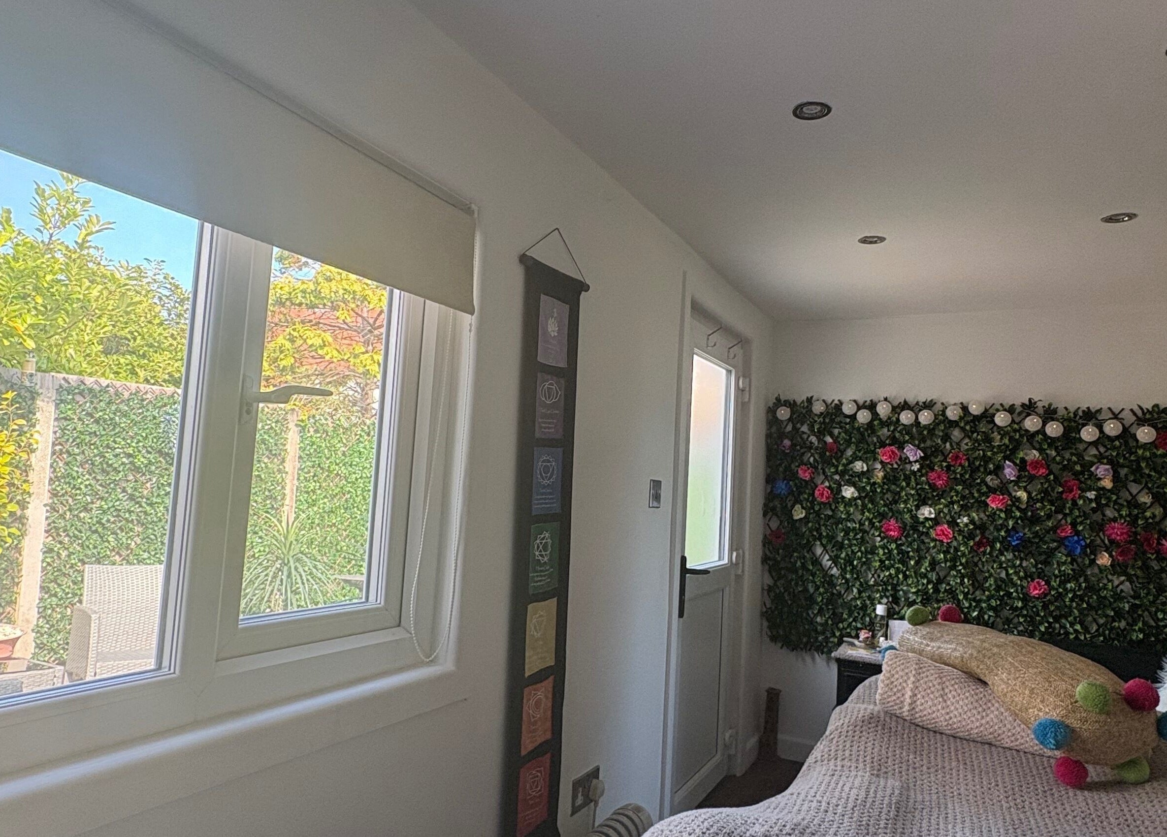 Peaceful room at Pampered@62 in Blackpool, England featuring a floral wall and garden view.