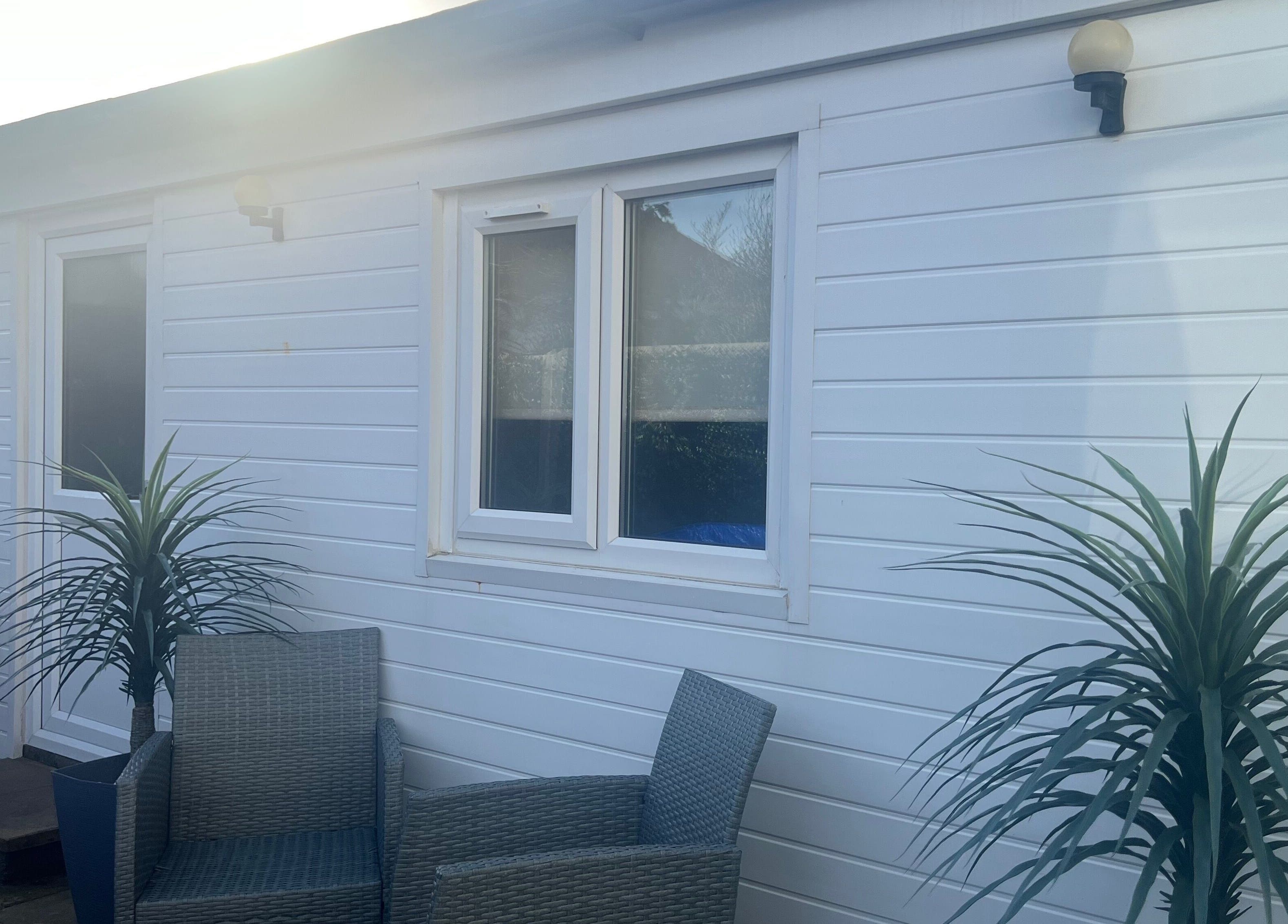 Outdoor seating area at Pampered@62, Blackpool, England, GB with chairs and plants.