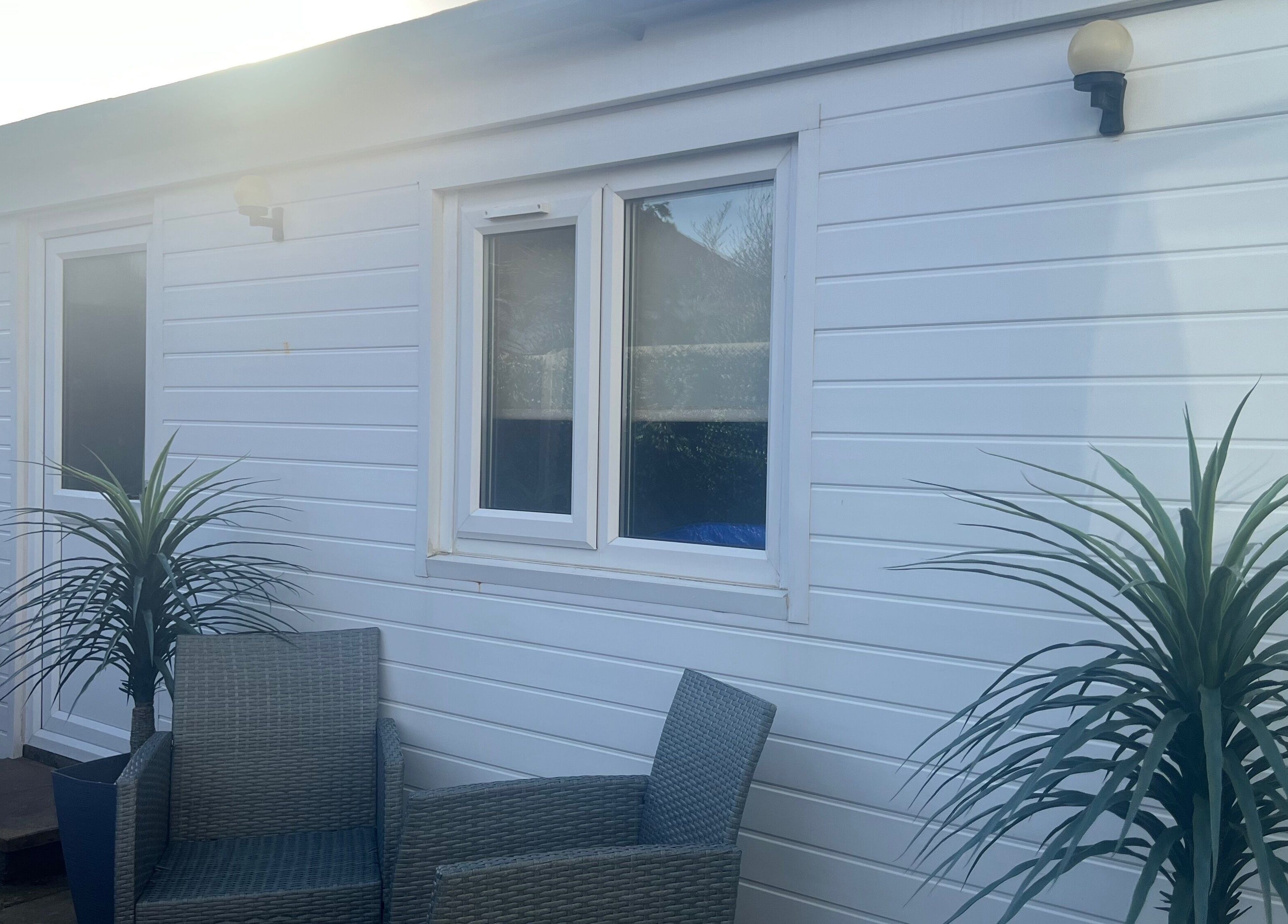 Outdoor seating area at Pampered@62, Blackpool, England, GB with chairs and plants.