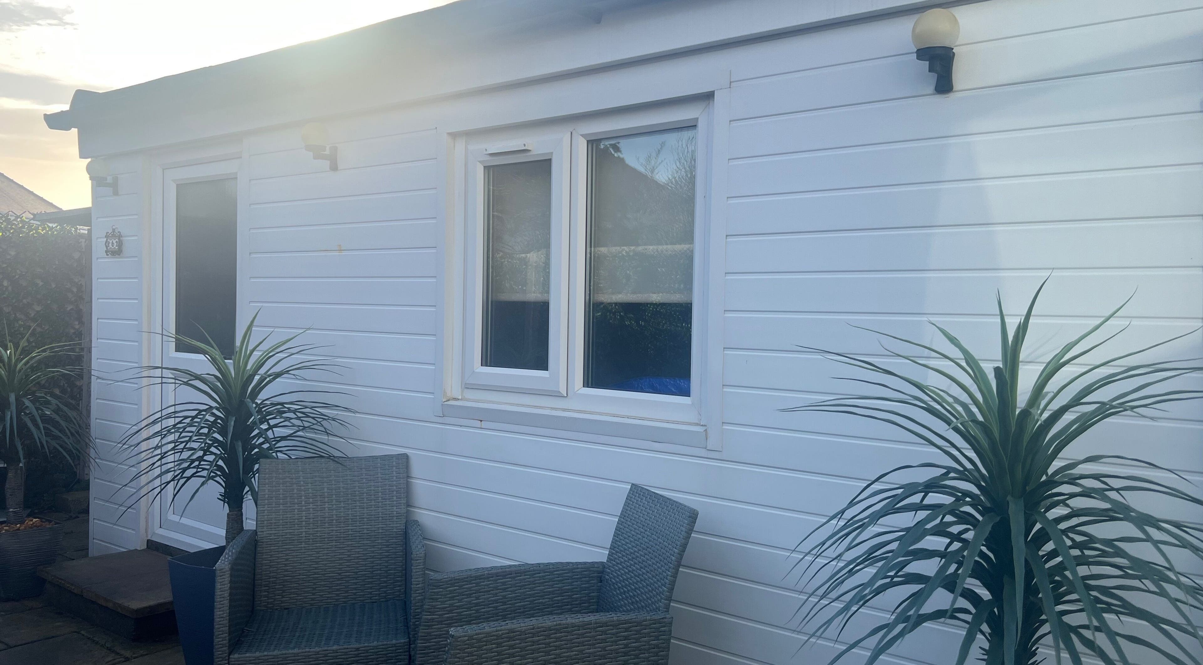 Outdoor seating area at Pampered@62, Blackpool, England, GB with chairs and plants.