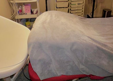 Cozy treatment bed at Esthora Aesthetics in London, England, GB, designed for ultimate relaxation.