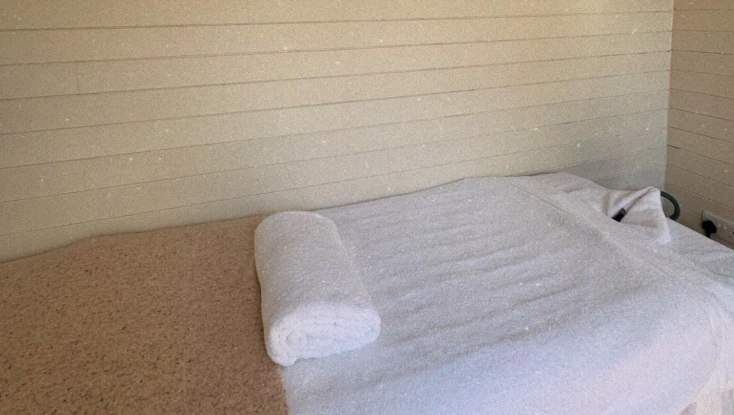 Cozy massage table at Wellness Studio, Bristol, England, GB, ready for a relaxing therapy session.