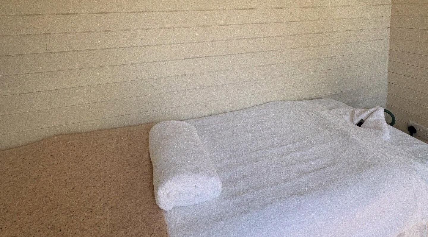 Cozy massage table at Wellness Studio, Bristol, England, GB, ready for a relaxing therapy session.