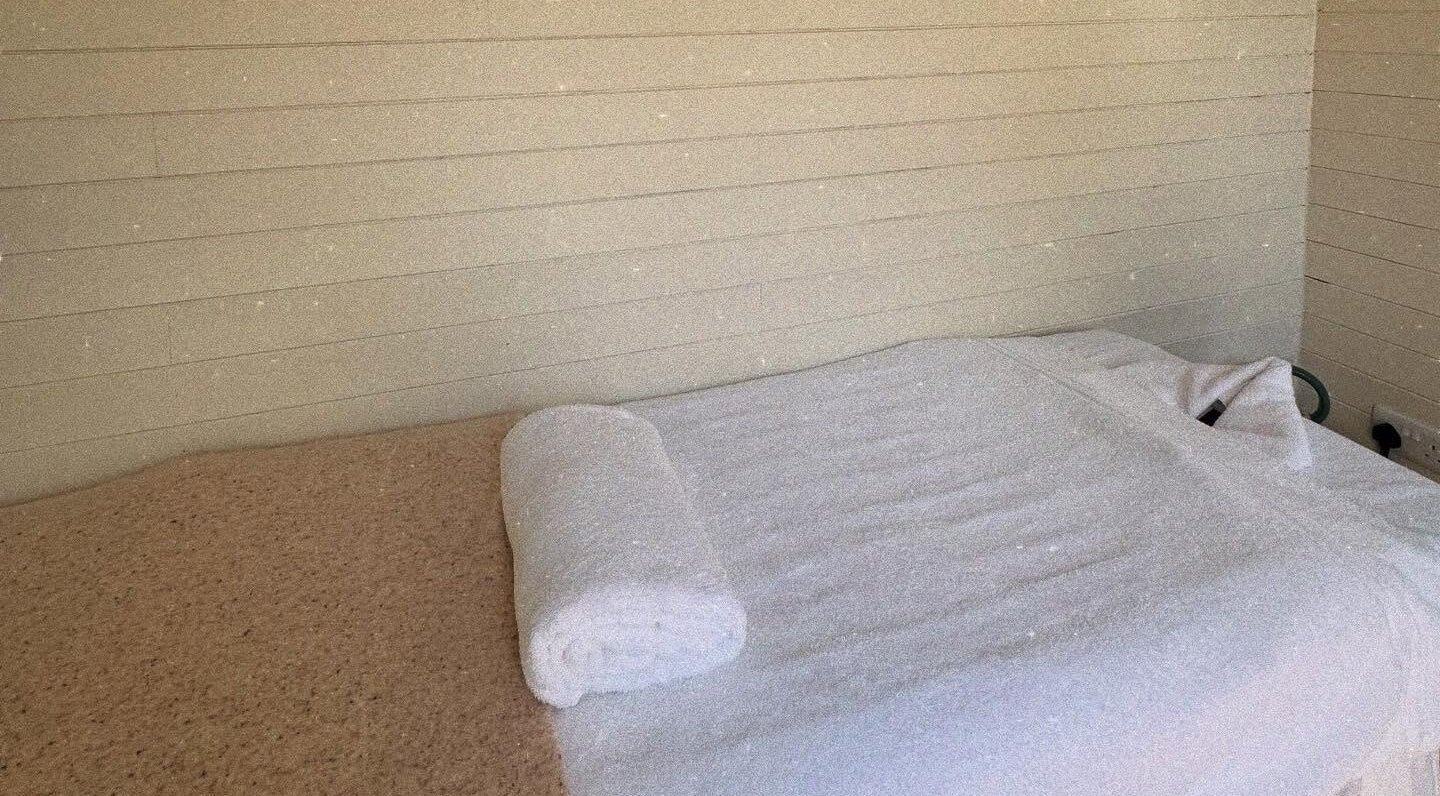 Cozy massage table at Wellness Studio, Bristol, England, GB, ready for a relaxing therapy session.