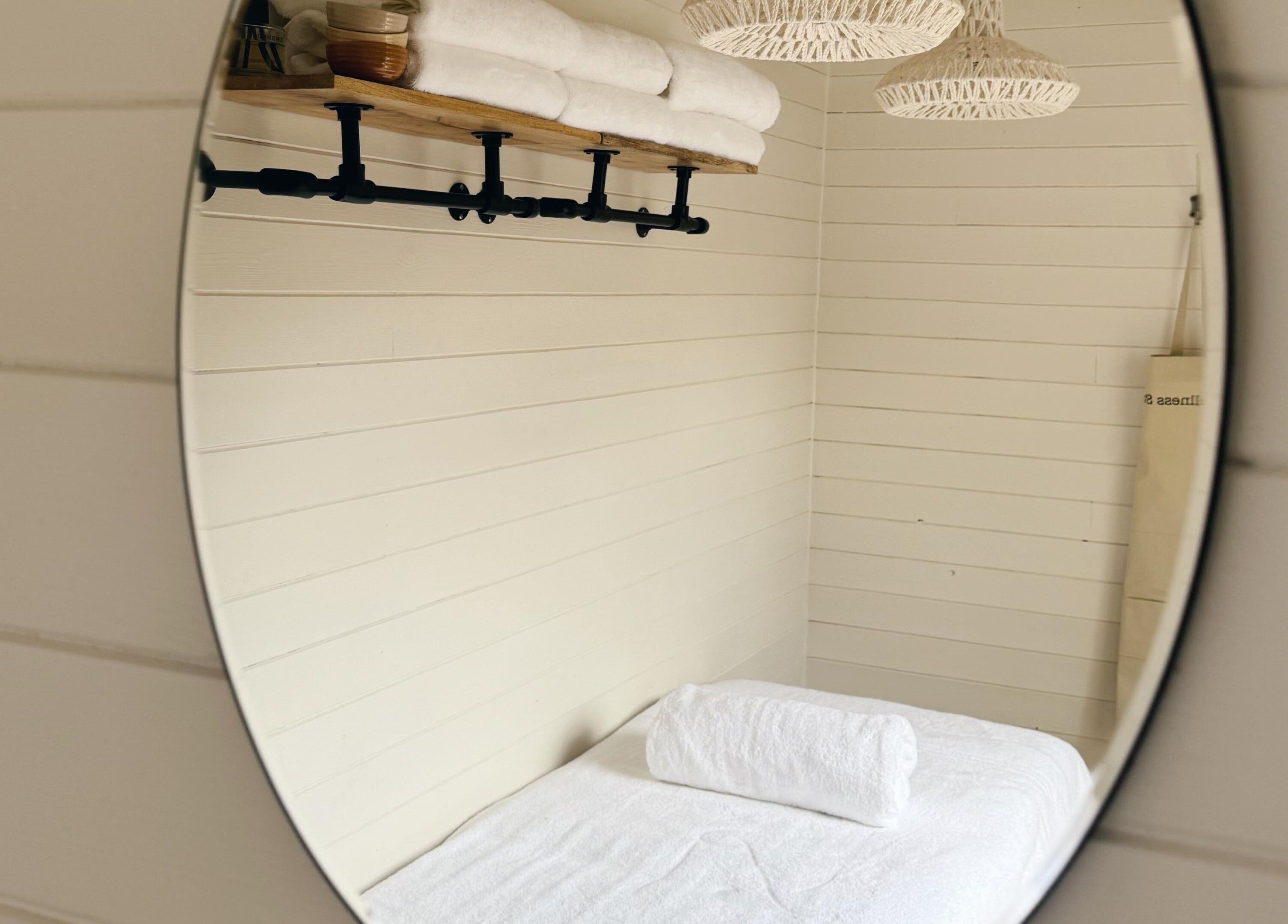 Elegant therapy room at Wellness Studio in Bristol, England, GB with rolled towels and soothing ambience.