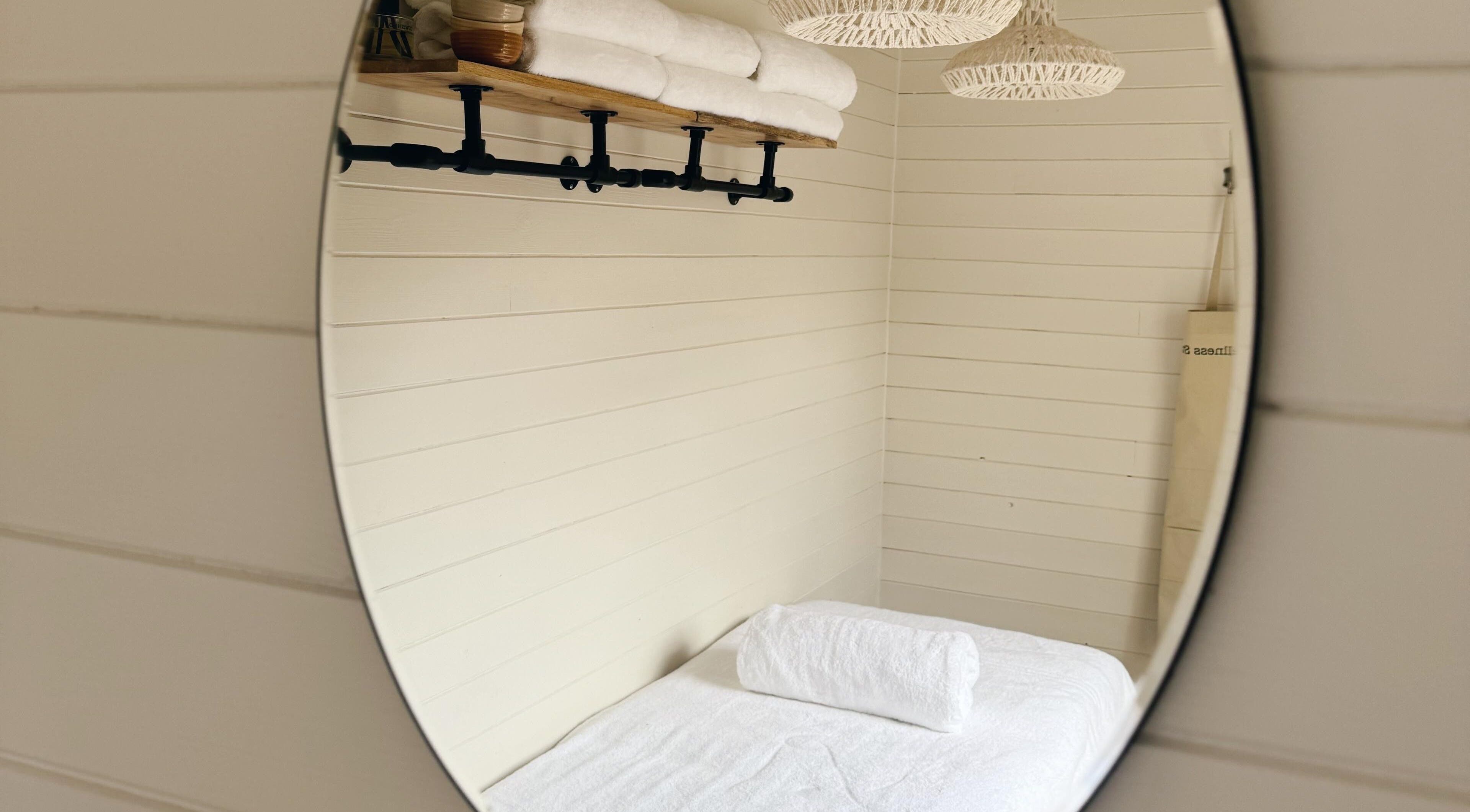 Elegant therapy room at Wellness Studio in Bristol, England, GB with rolled towels and soothing ambience.