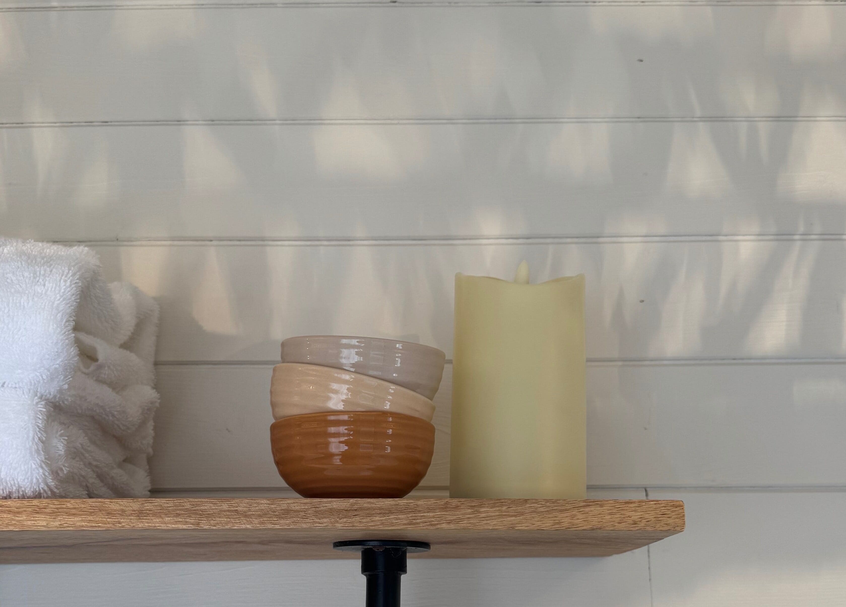 Tranquil shelf with towels, bowls, and candle at Wellness Studio, Bristol, England, GB.