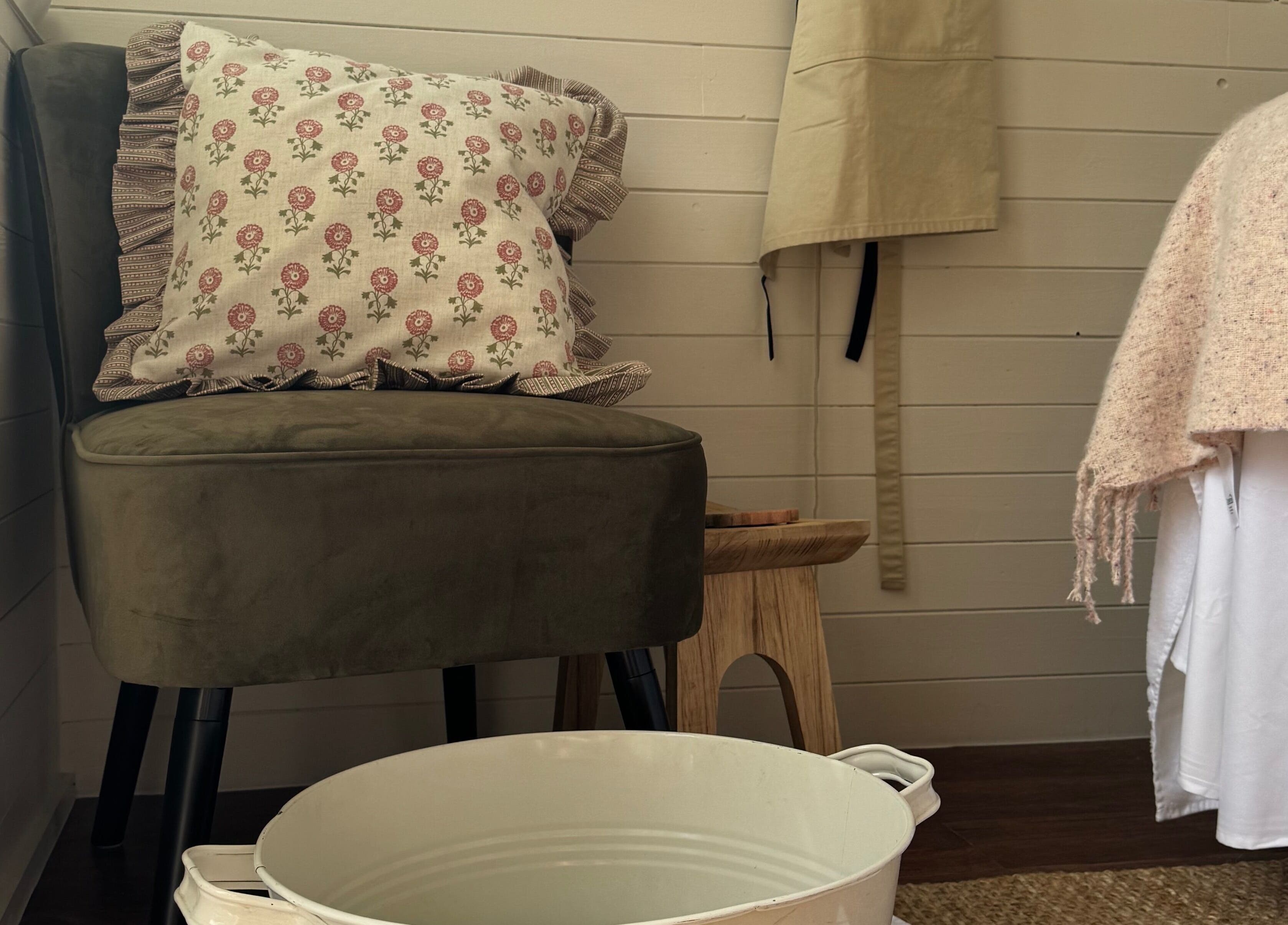 Cozy seating area in Wellness Studio, Bristol, England, GB with a plush chair and floral pillow.